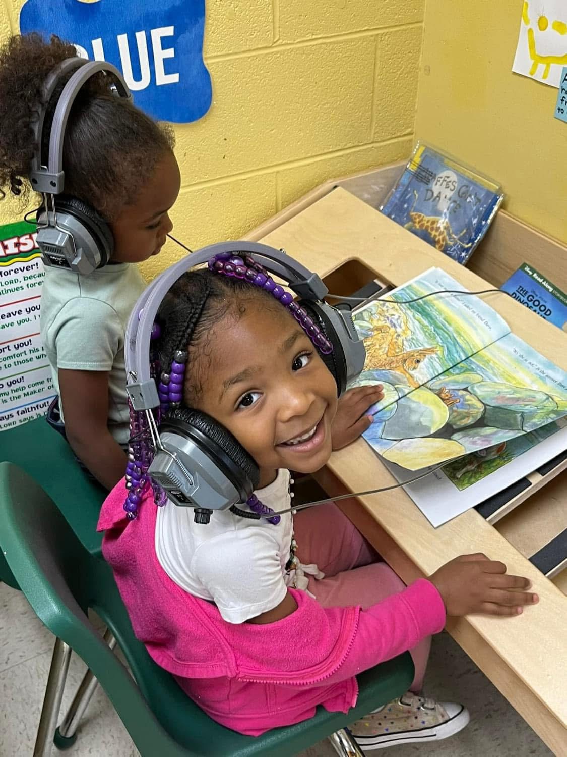 Smiling Ladybugs students listening to a story together