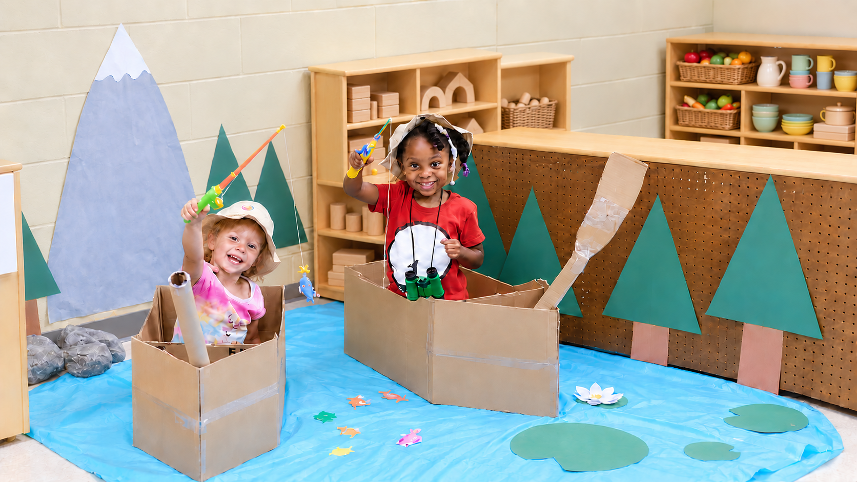 Two children exploring a cardboard pretend-play activity in a Learning Garden classroom