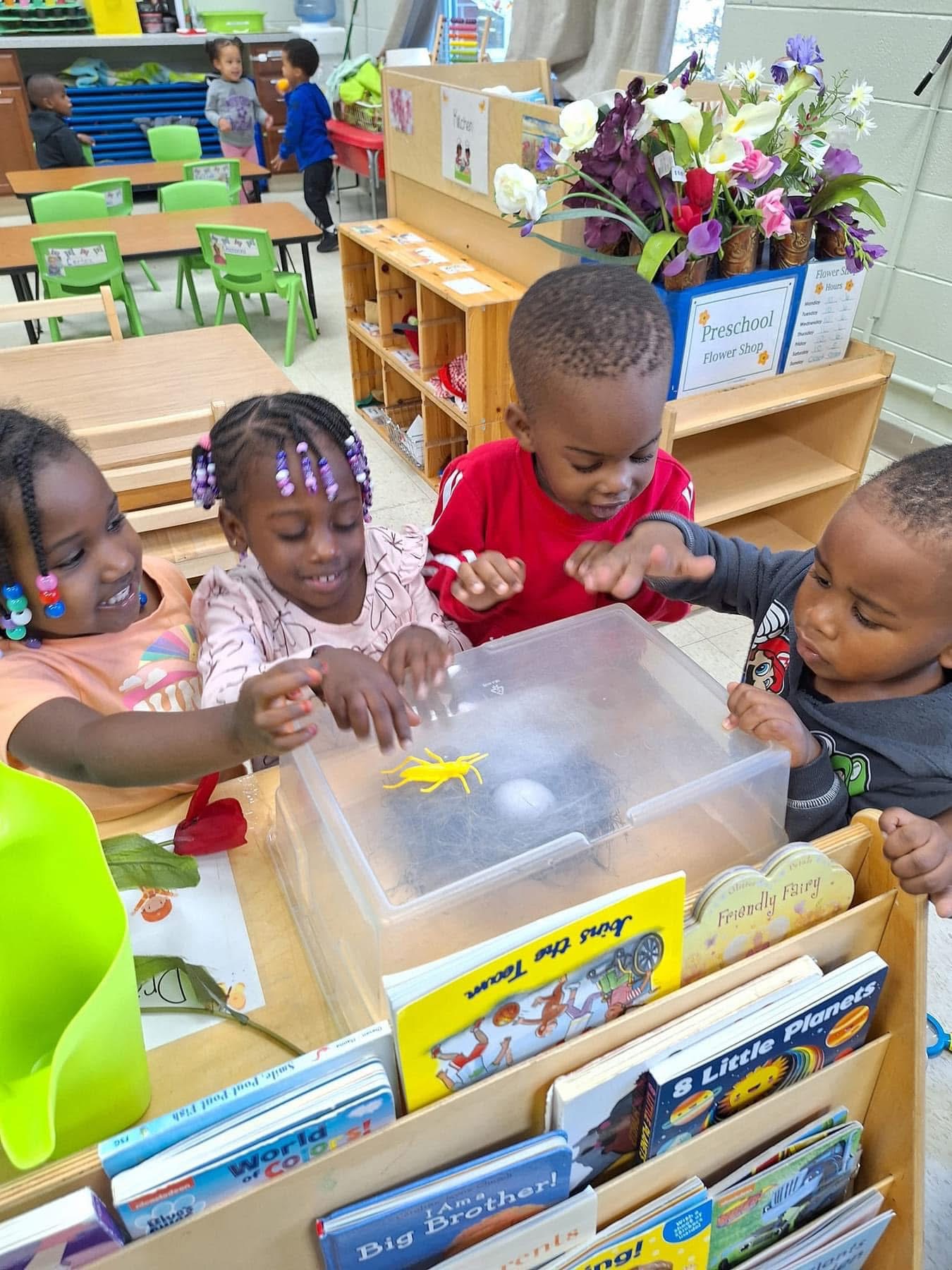 Children are engaged together at a classroom play station.