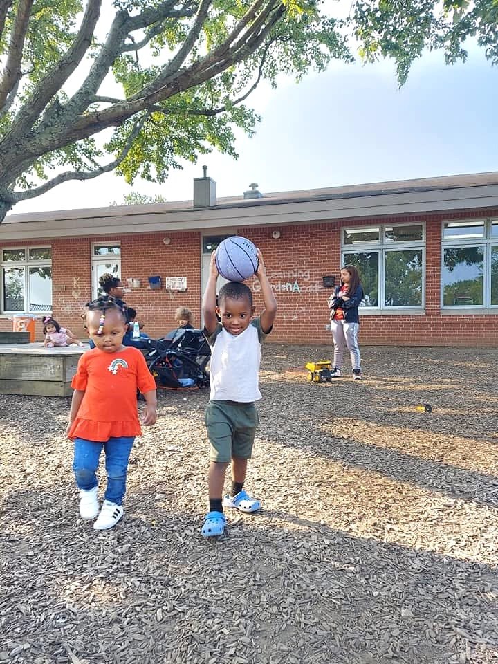 Children explore the outdoor play space together.