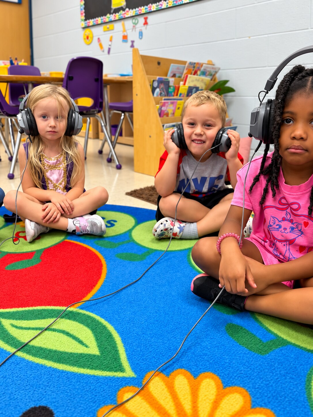 Children gather together to listen during group time.
