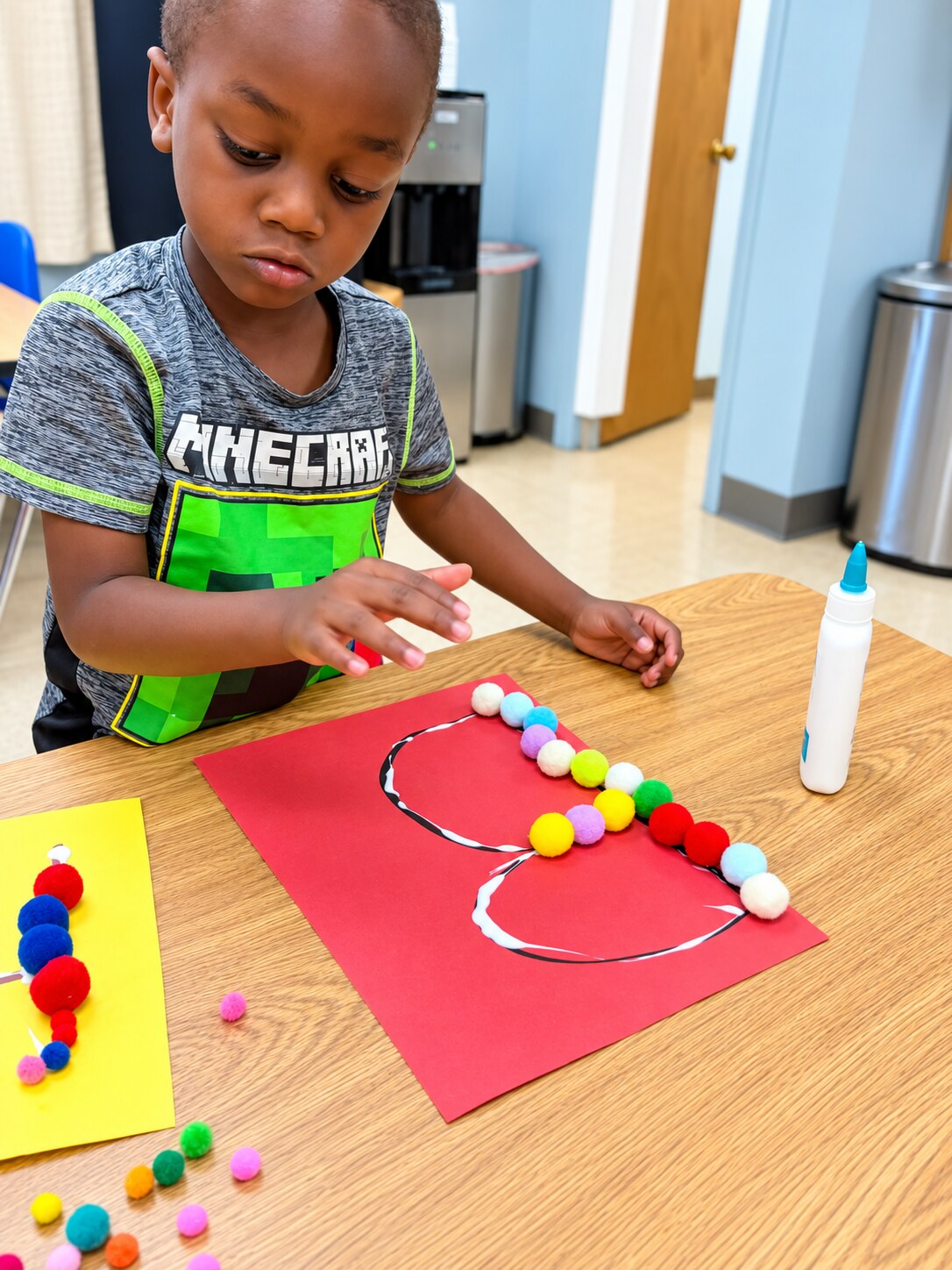 A child strings colorful materials during a fine-motor activity.
