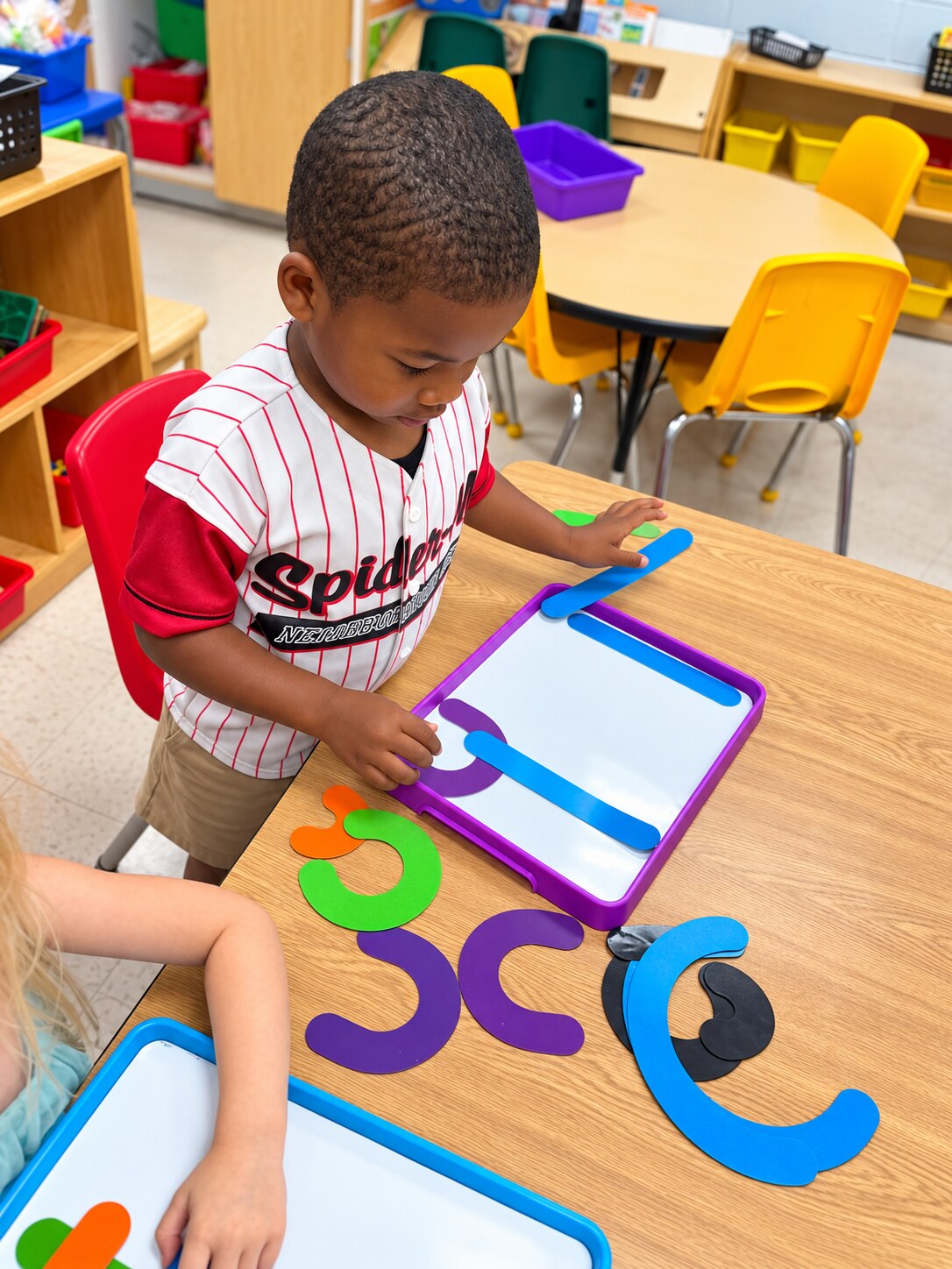 A child explores a shape and number manipulative.