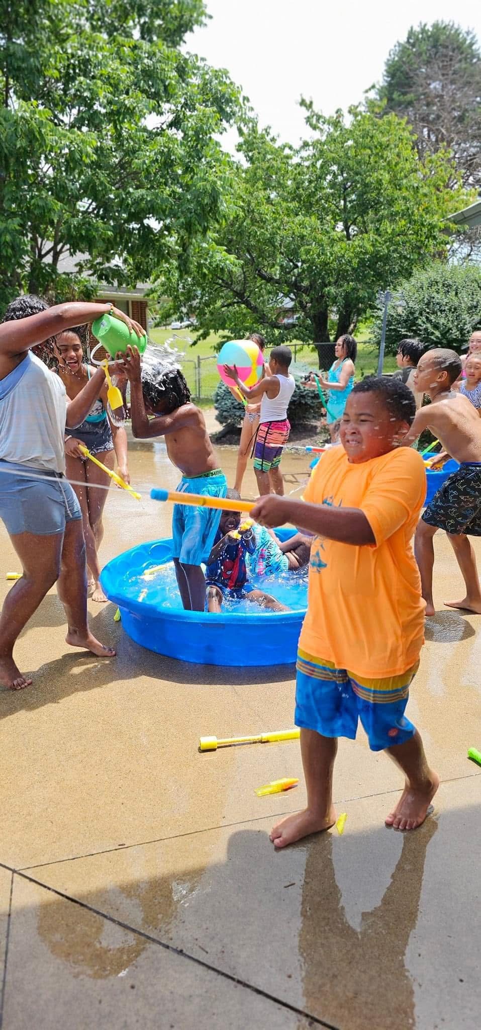 Children splash and explore during outdoor water play.