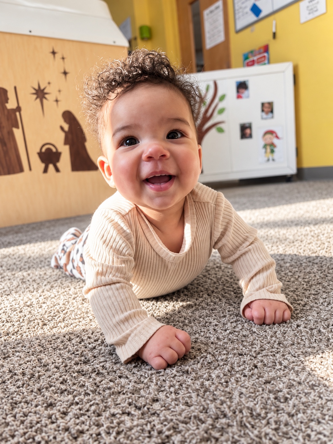A baby explores the classroom floor during movement play.