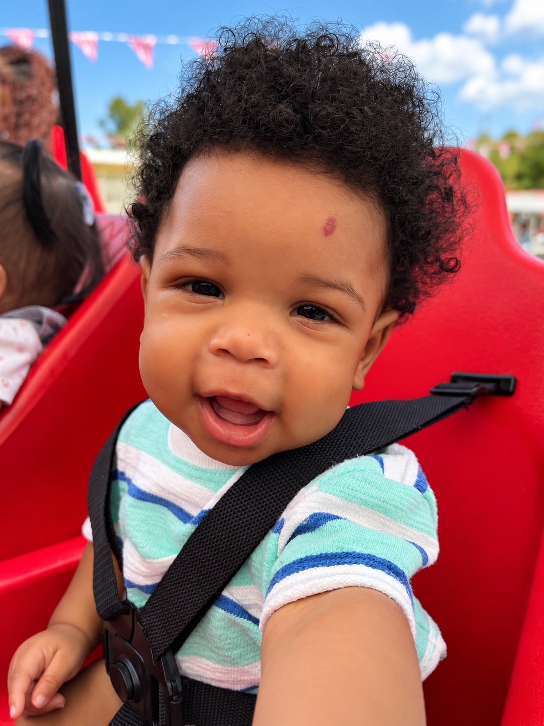 An infant enjoys fresh air during outdoor time.